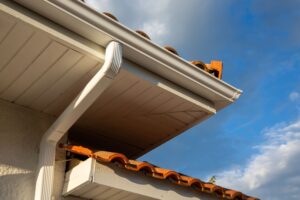 Close-up view of beige gutters on a home